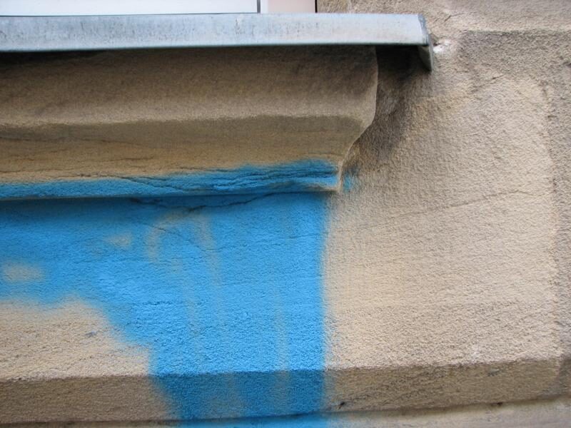Blaue Farbe von Sandsteinsockel und Gesims entfernt